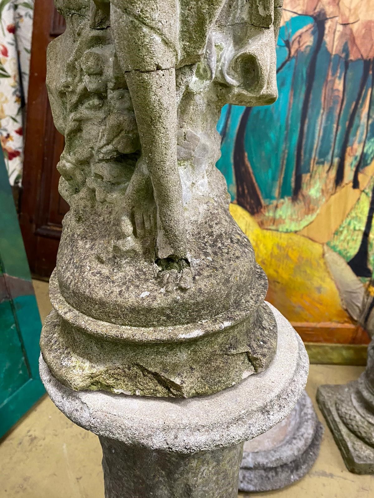 Two reconstituted stone figural garden ornaments on stands, larger 128cm high